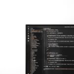 a computer monitor sitting on top of a desk