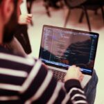 a man sitting in front of a laptop computer