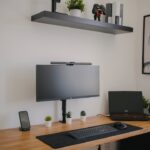 black flat screen computer monitor on brown wooden desk