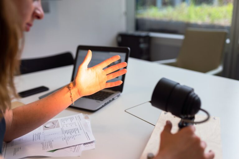 person using macbook pro on table