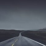 photography of road under cloudy sky